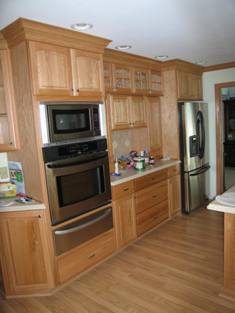 HMI Remodeling-Hoske Maintenance-removed old kitchen cabinets, appliances, flooring and worked with customer to choose new cabinets, counters, appliance, hardwood flooring, ceramic tile backsplash and double crown molding.